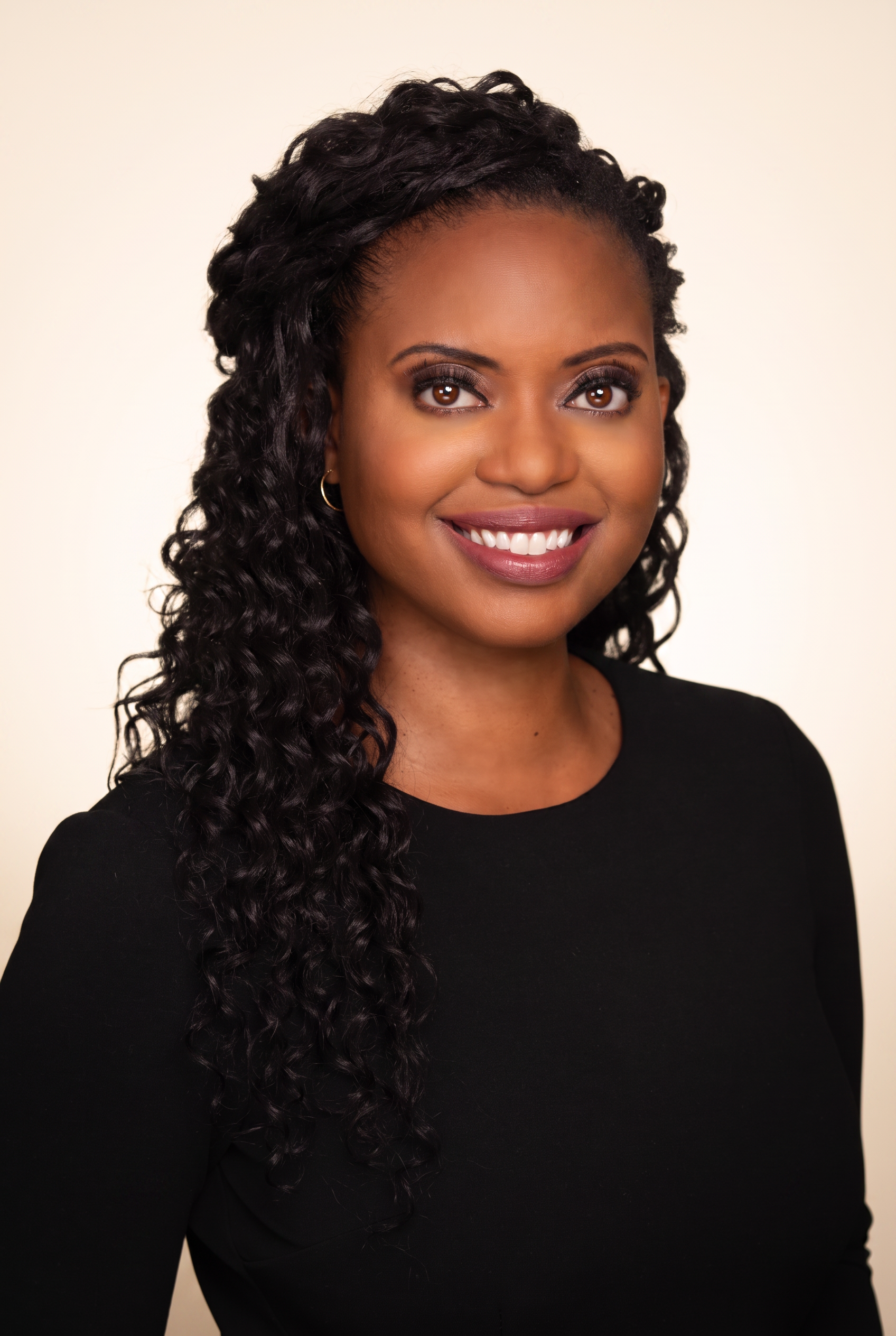 Kwanza, founder of Lionheart Wealth, smiling in a portrait